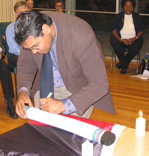 ADen_signing_the_poverty_pole